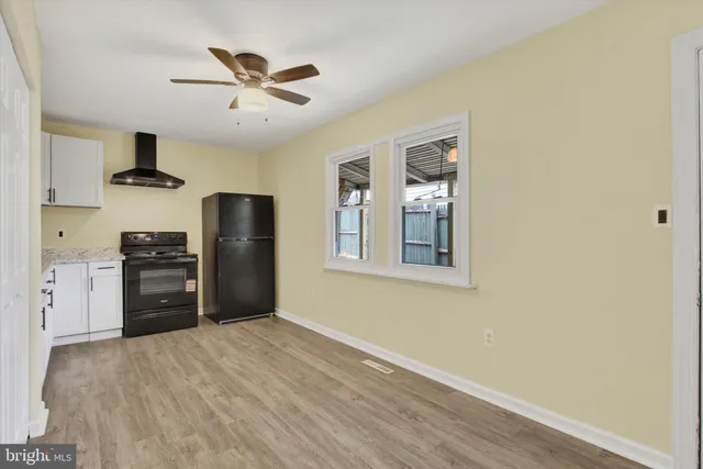a kitchen with stainless steel appliances a refrigerator and a stove top oven