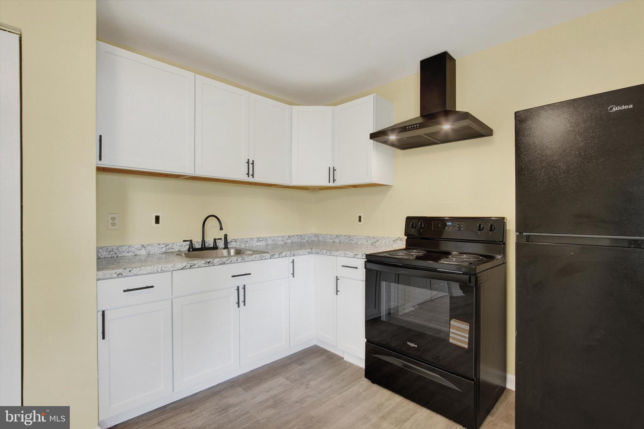 108 Walnut Street Steelton, PA 17113 - Photo 7 of 26 a kitchen with stainless steel appliances granite countertop a sink stove and refrigerator