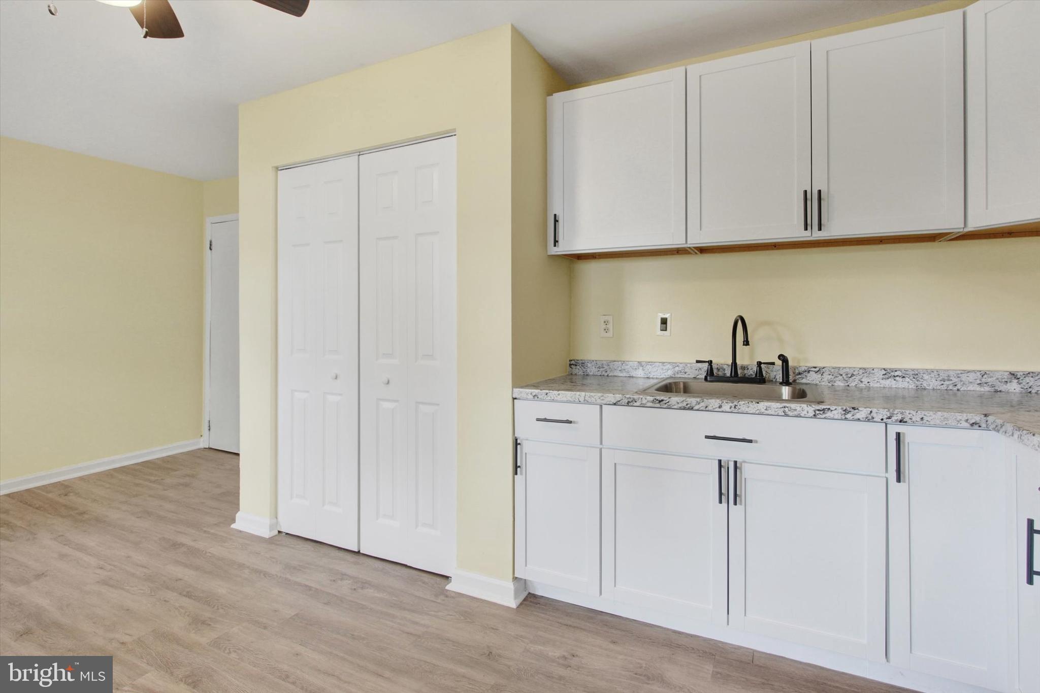 108 Walnut Street Steelton, PA 17113 - Photo 8 of 26 a kitchen with stainless steel appliances granite countertop a sink and dishwasher with white cabinets