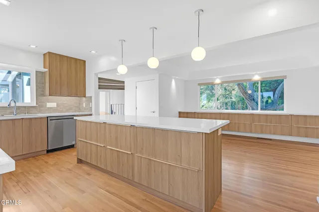 a view of a room with wooden floor and windows