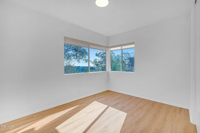a view of a house with a large windows and flower garden