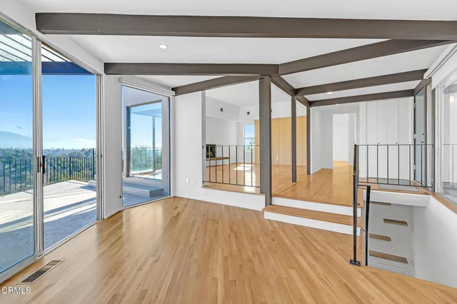 a kitchen with granite countertop cabinets stainless steel appliances and wooden floor