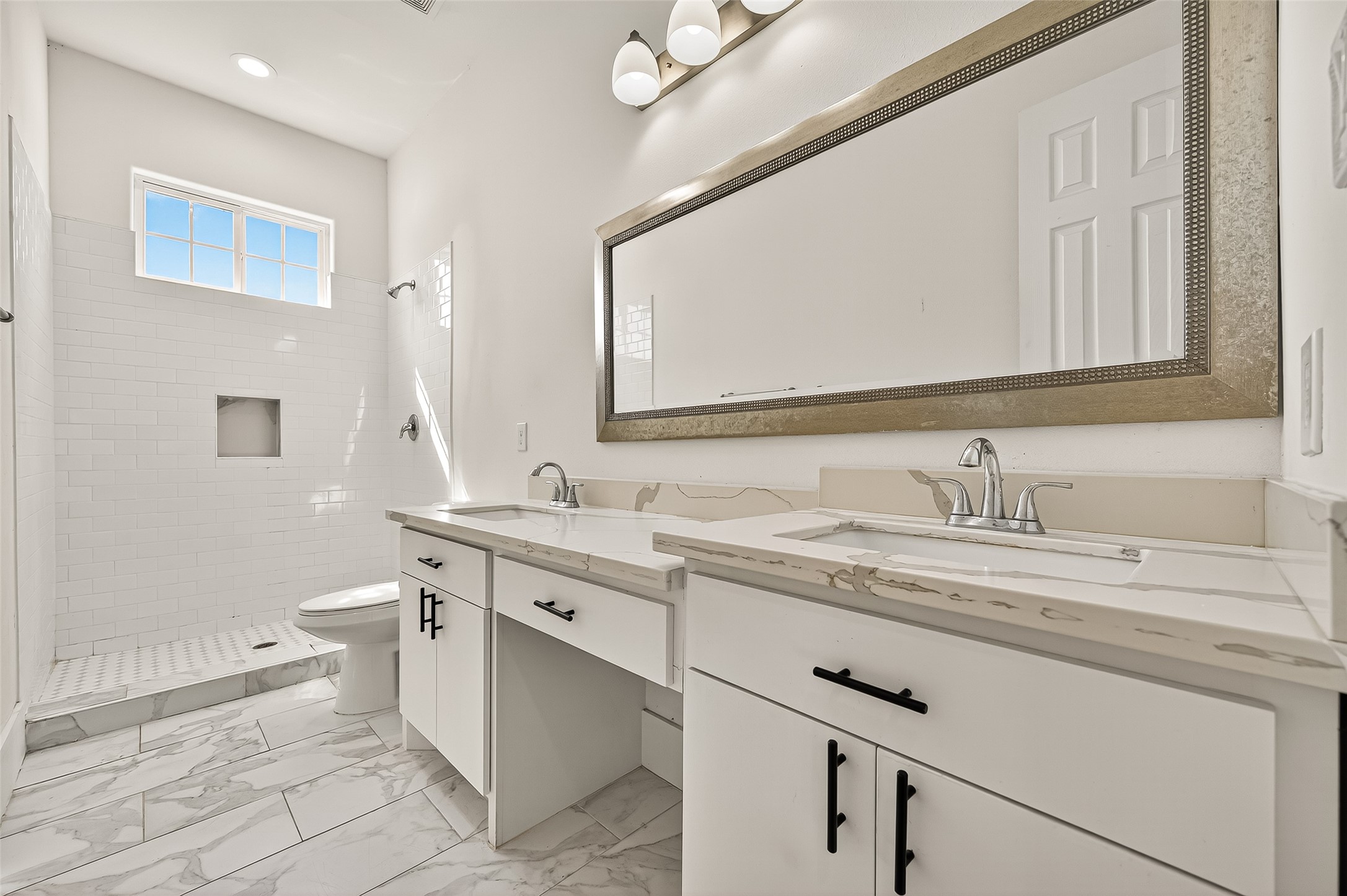 7915 Kirk Road Rosenberg, TX 77471 - Photo 29 of 46 a bathroom with a granite countertop sink a toilet and a mirror