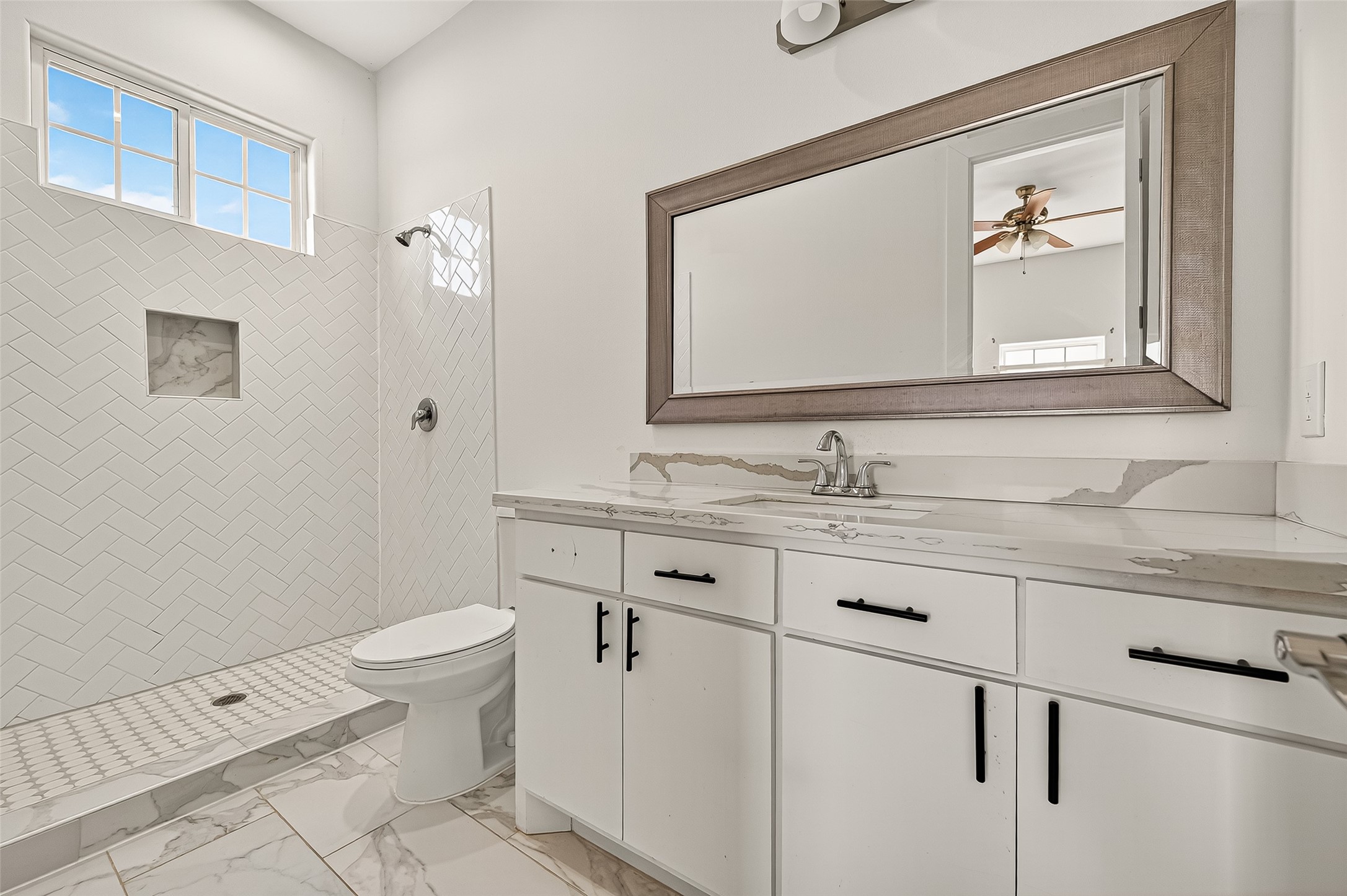 7915 Kirk Road Rosenberg, TX 77471 - Photo 31 of 46 a bathroom with a granite countertop toilet sink and mirror