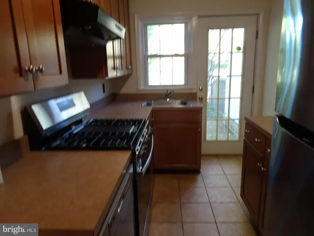 a kitchen with a refrigerator and a stove