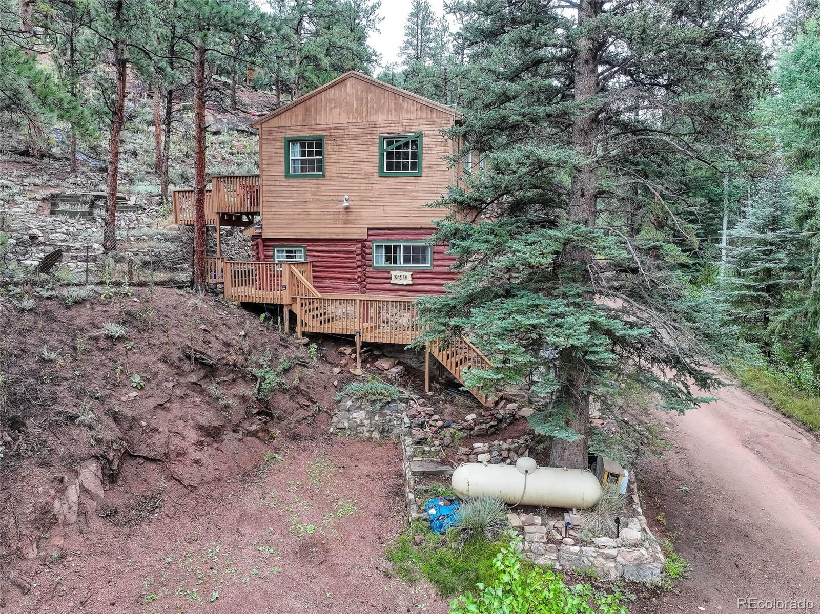27403 Schuyler Gulch Road Pine, CO 80470 - Photo 14 of 40 a view of a chair and table in backyard