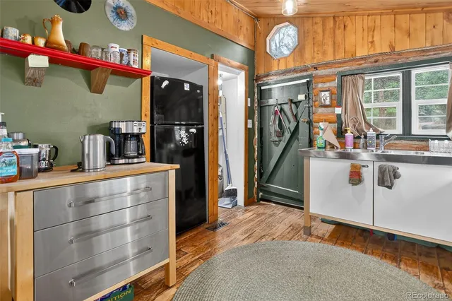 a view of a red and white house with wooden fence