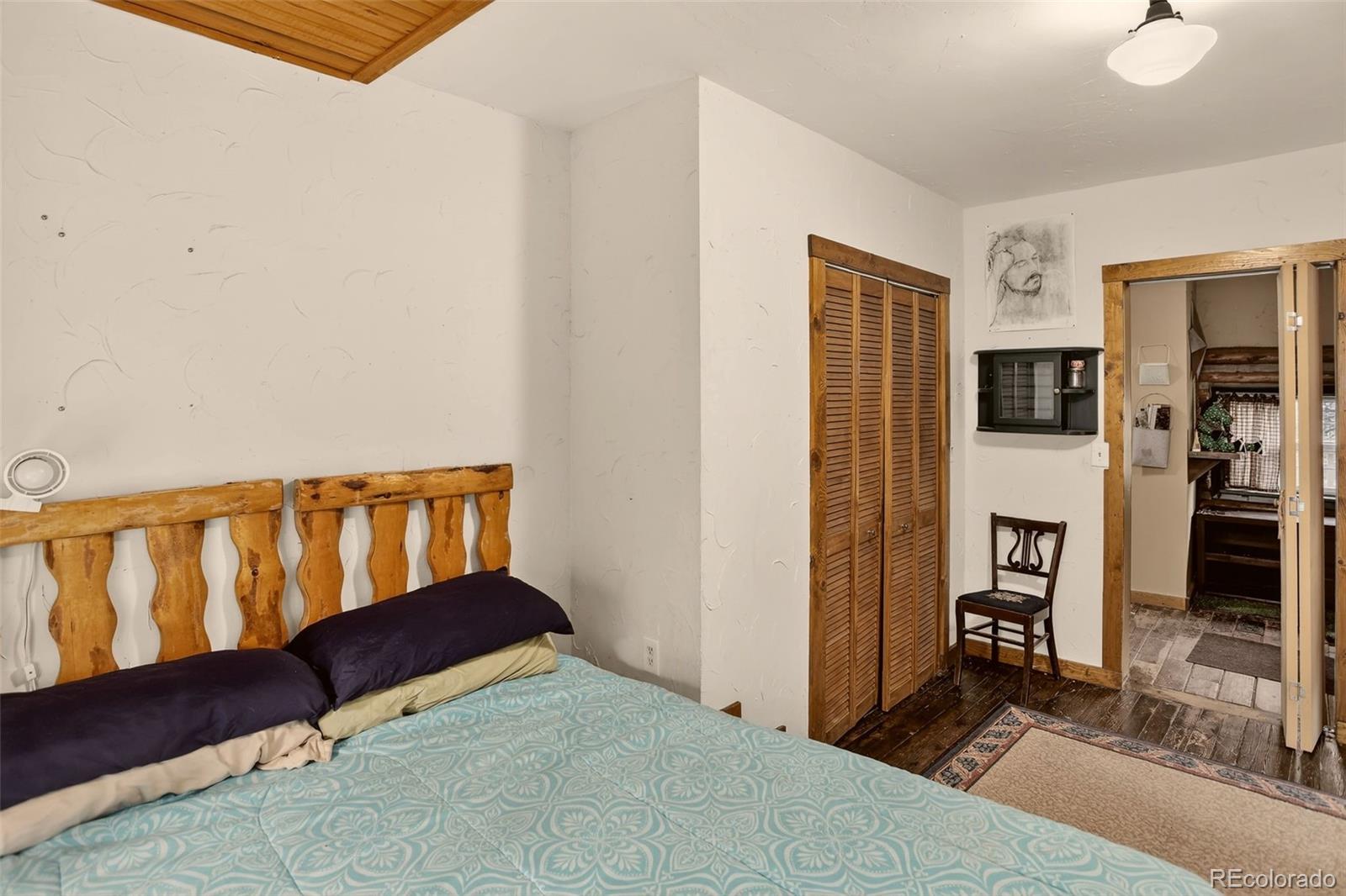27403 Schuyler Gulch Road Pine, CO 80470 - Photo 24 of 40 a bedroom with a bed and a window