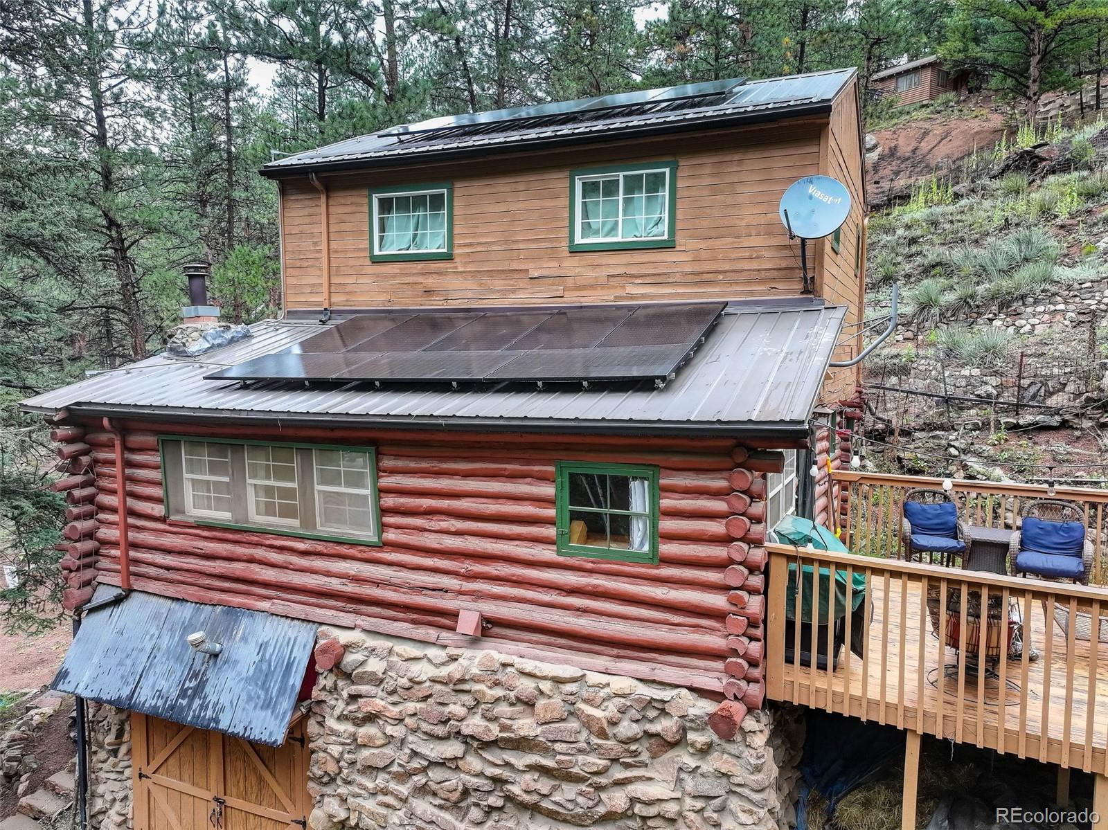 27403 Schuyler Gulch Road Pine, CO 80470 - Photo 25 of 40 a front view of a house with garden