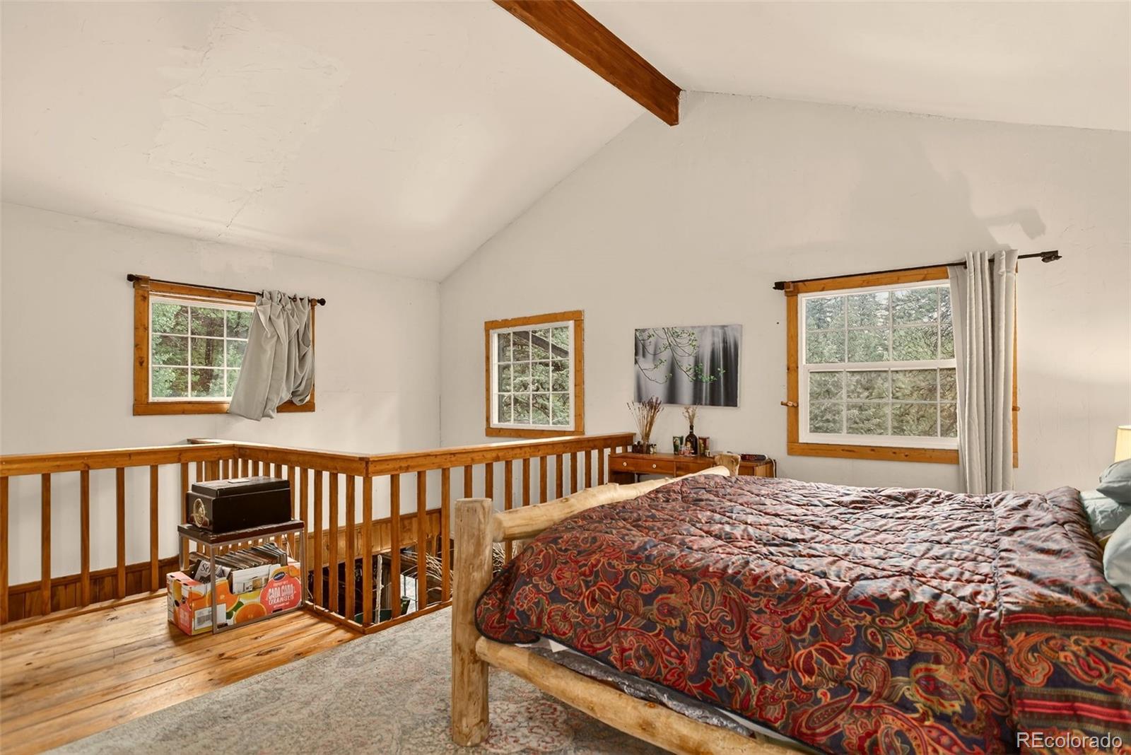27403 Schuyler Gulch Road Pine, CO 80470 - Photo 28 of 40 a bed sitting in a bedroom next to a window