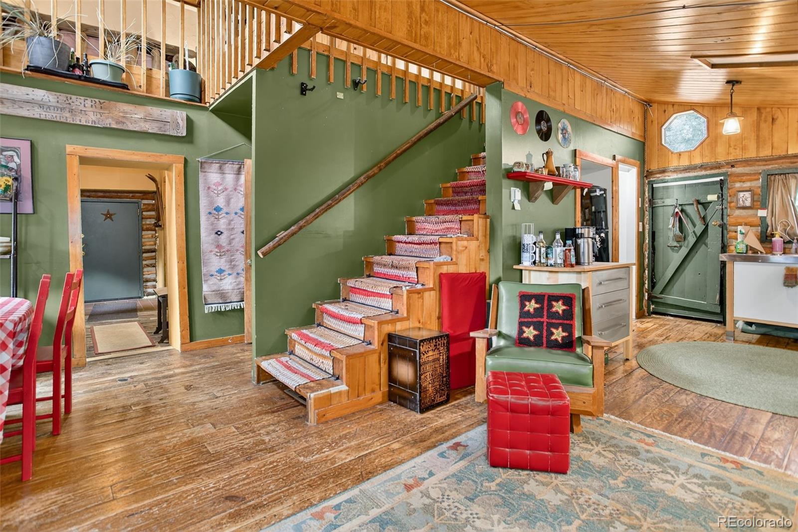 27403 Schuyler Gulch Road Pine, CO 80470 - Photo 3 of 40 a room with lots of white walls and stairs