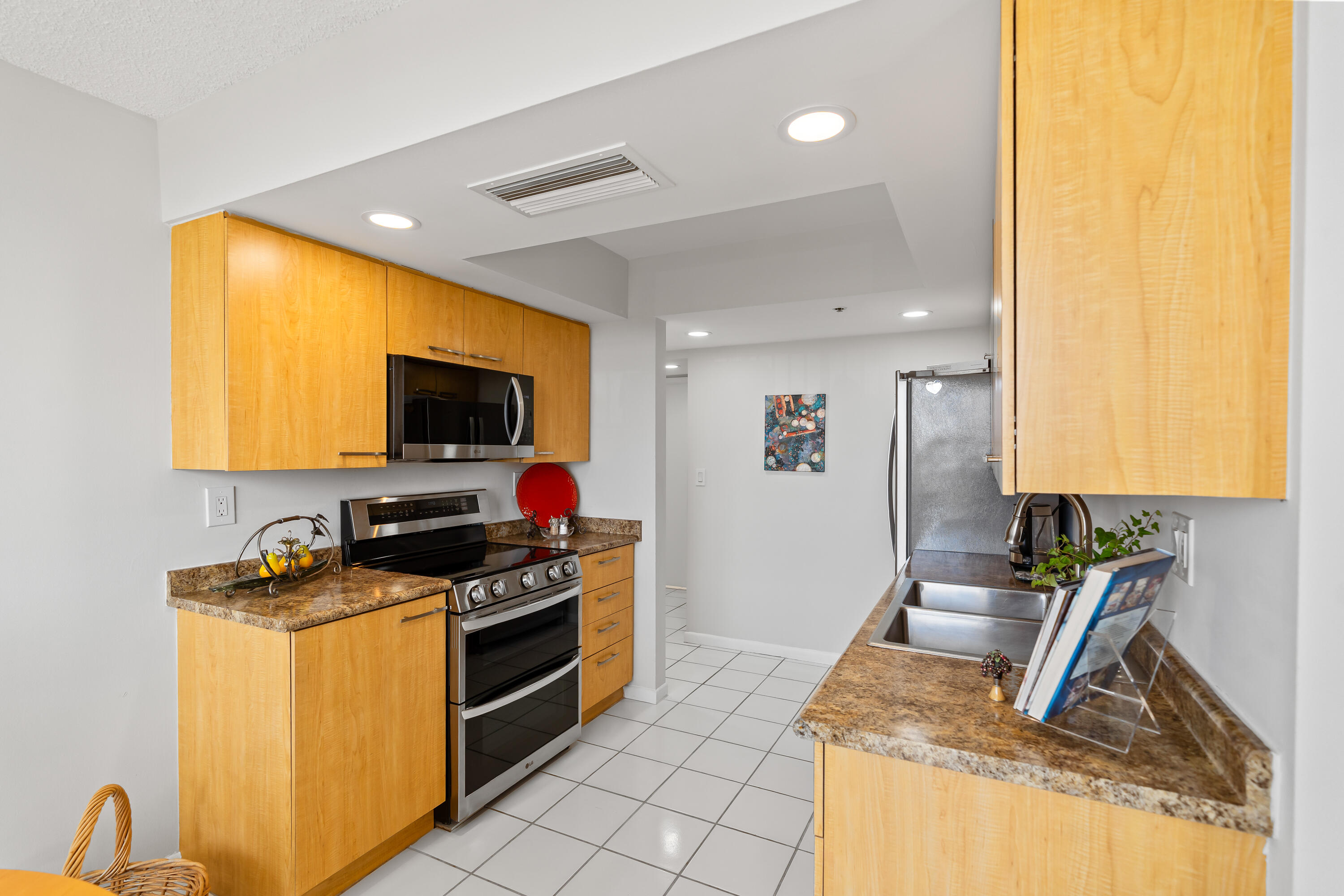 23200 Camino Del Mar, Unit 603 Boca Raton, FL 33433 - Photo 12 of 43 a kitchen with a sink stove and microwave
