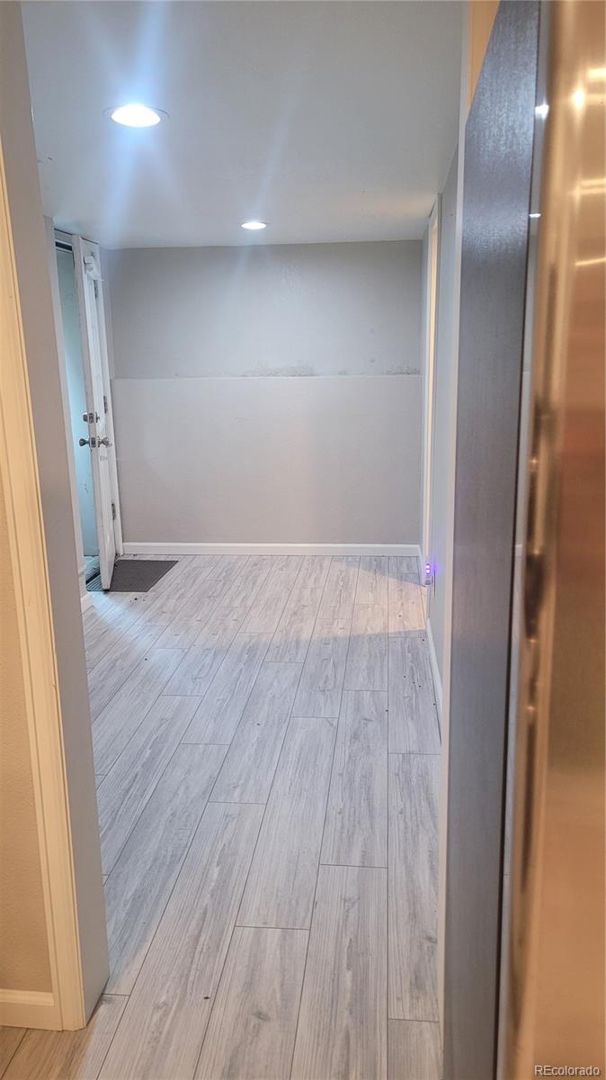 2834 Curtis Street, Unit 3 Denver, CO 80205 - Photo 6 of 22 wooden floor in an empty room with a mirror