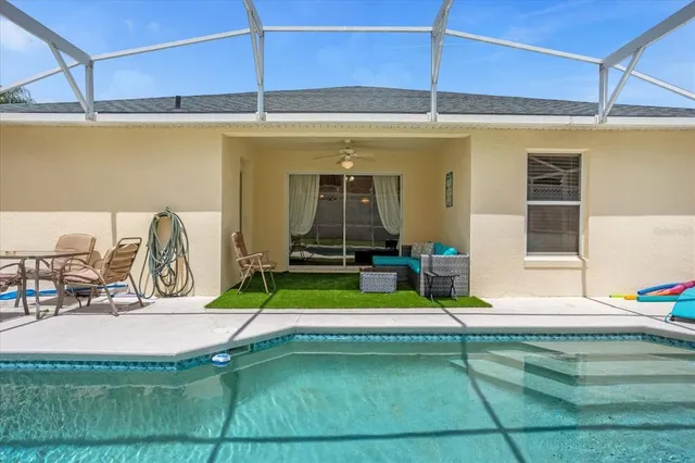 a view of a patio with table and chairs under an umbrella