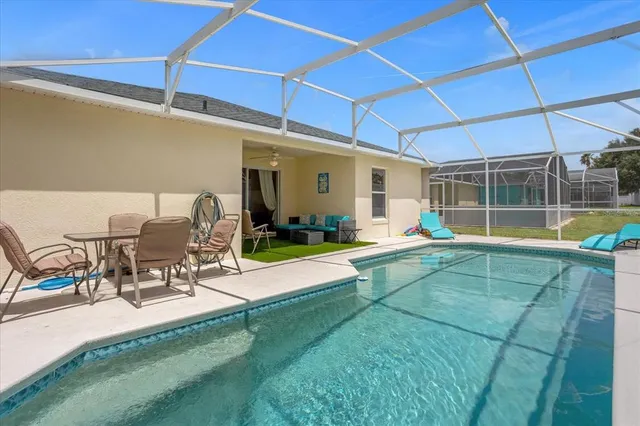 a view of swimming pool with seating space