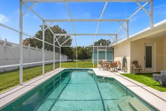 a view of a backyard with swimming pool
