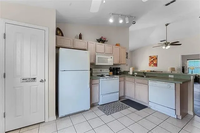 a kitchen with white cabinets and white appliances