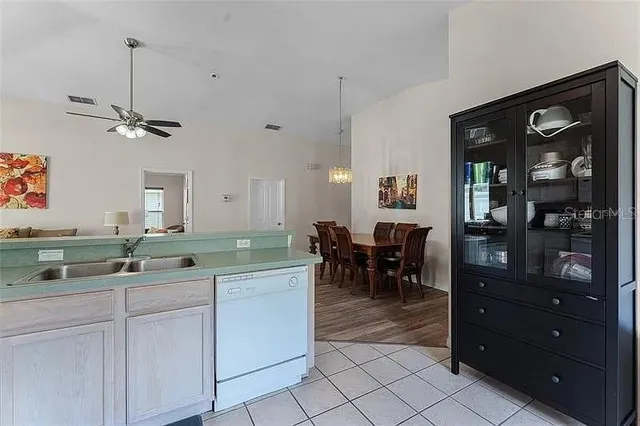 a living room with furniture a rug and a lamp