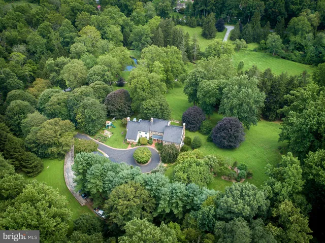 an aerial view of a house with a swimming pool