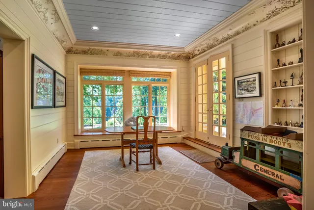 a living room with furniture and a floor to ceiling window