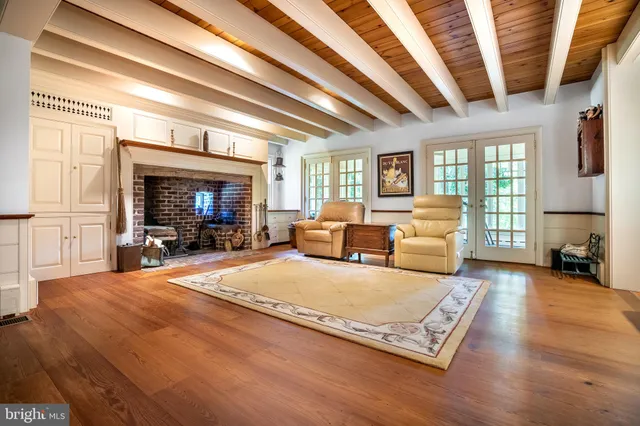 a bedroom with furniture and a large window