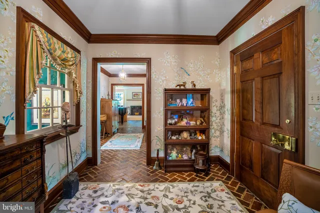a view of a hallway with wooden floor and furniture
