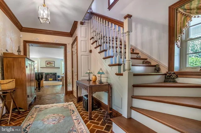 a view of entryway and hall with wooden floor