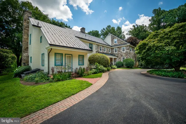 a front view of house with a garden