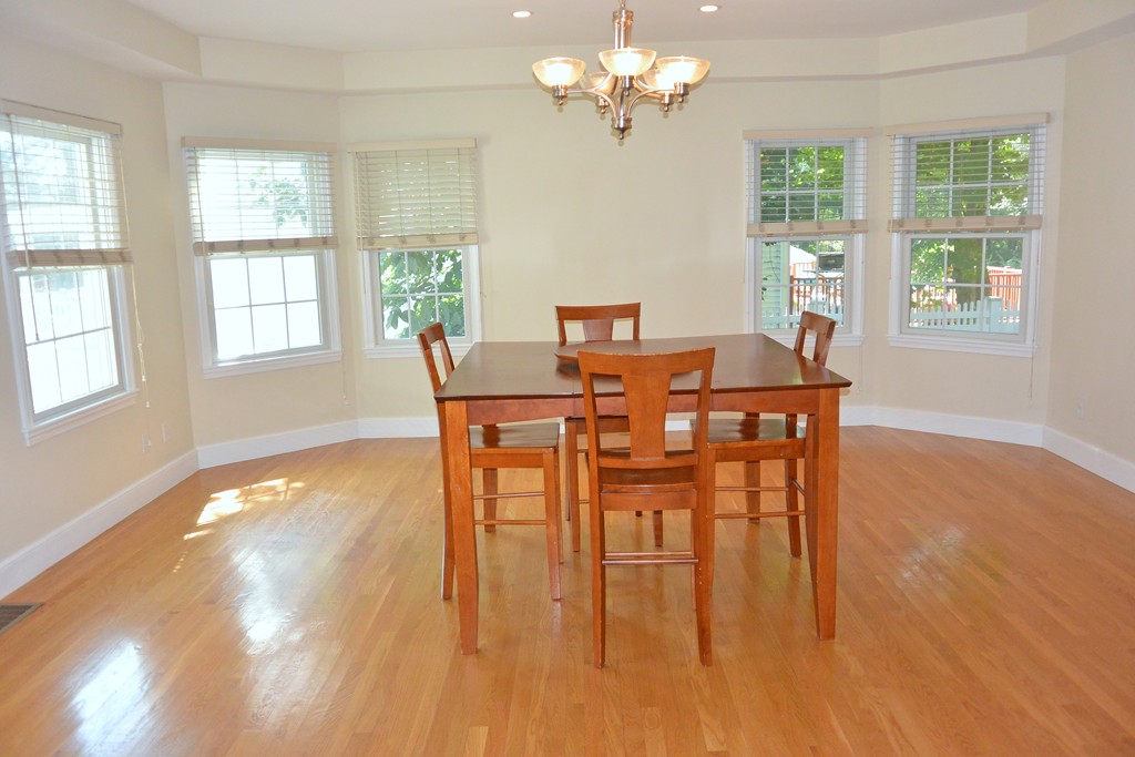 84 Spring Street Wakefield, MA 01880 - Photo 9 of 30 a view of a dining room with furniture a chandelier and wooden floor
