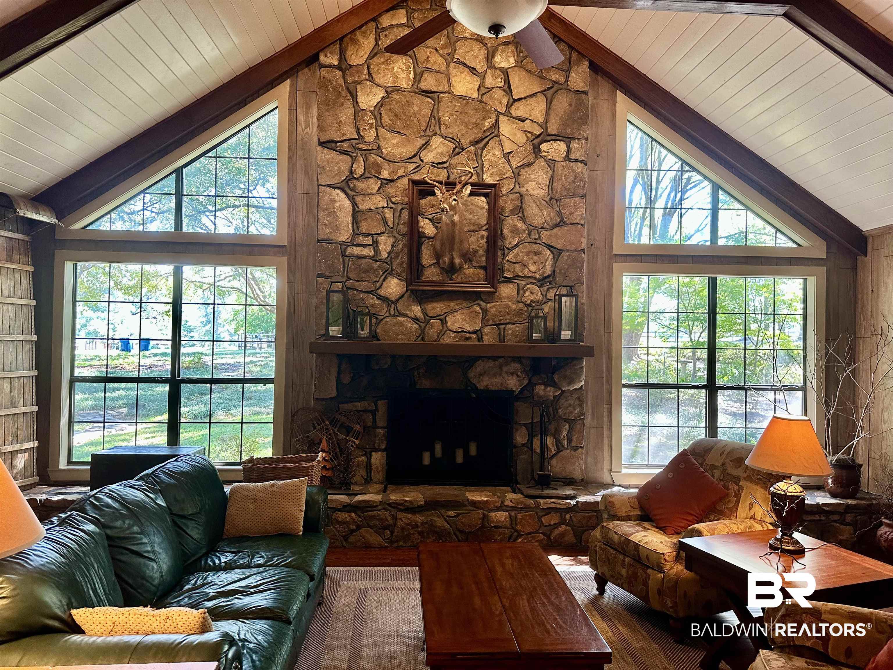 117 Belle Meade Brewton, AL 36426 - Photo 4 of 62 Living room with a stone fireplace, hardwood / wood-style flooring, and high vaulted ceiling
