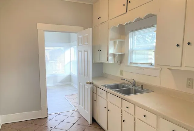 a kitchen with sink and cabinets