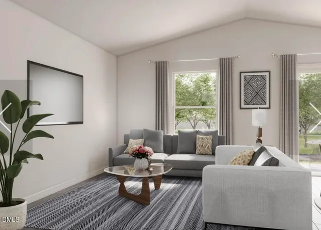 a living room with furniture and a potted plant