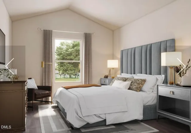 a bedroom with a bed wooden floor and window