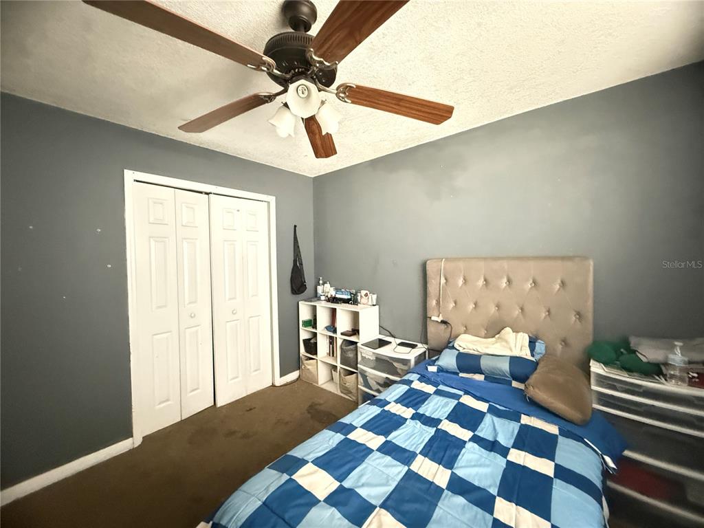 1944 South Conway Road, Unit 3 Orlando, FL 32812 - Photo 13 of 20 a bedroom with a bed and a chandelier