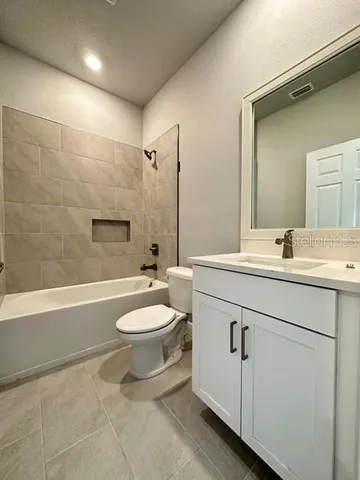 a bathroom with a double vanity sink toilet and shower