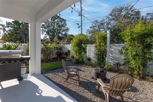 a view of a patio with table and chairs potted plants with wooden floor