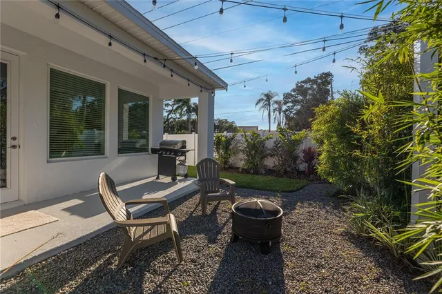 a view of a chairs and table in backyard of the house