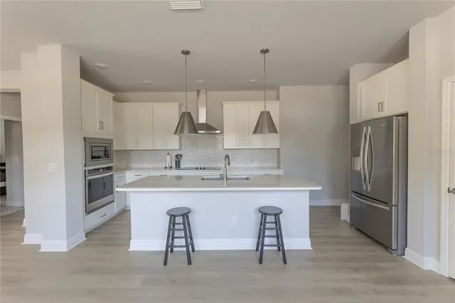 a kitchen with stainless steel appliances a sink stove and refrigerator