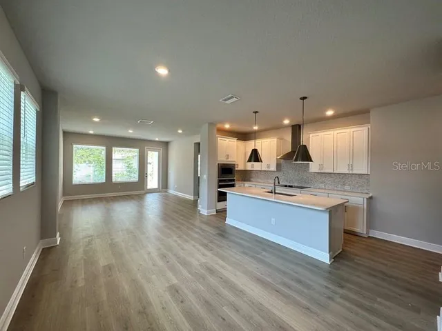 a view of kitchen with sink and wooden floor
