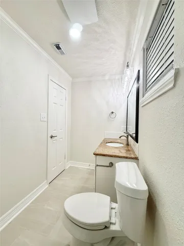 a bathroom with a toilet a sink and mirror