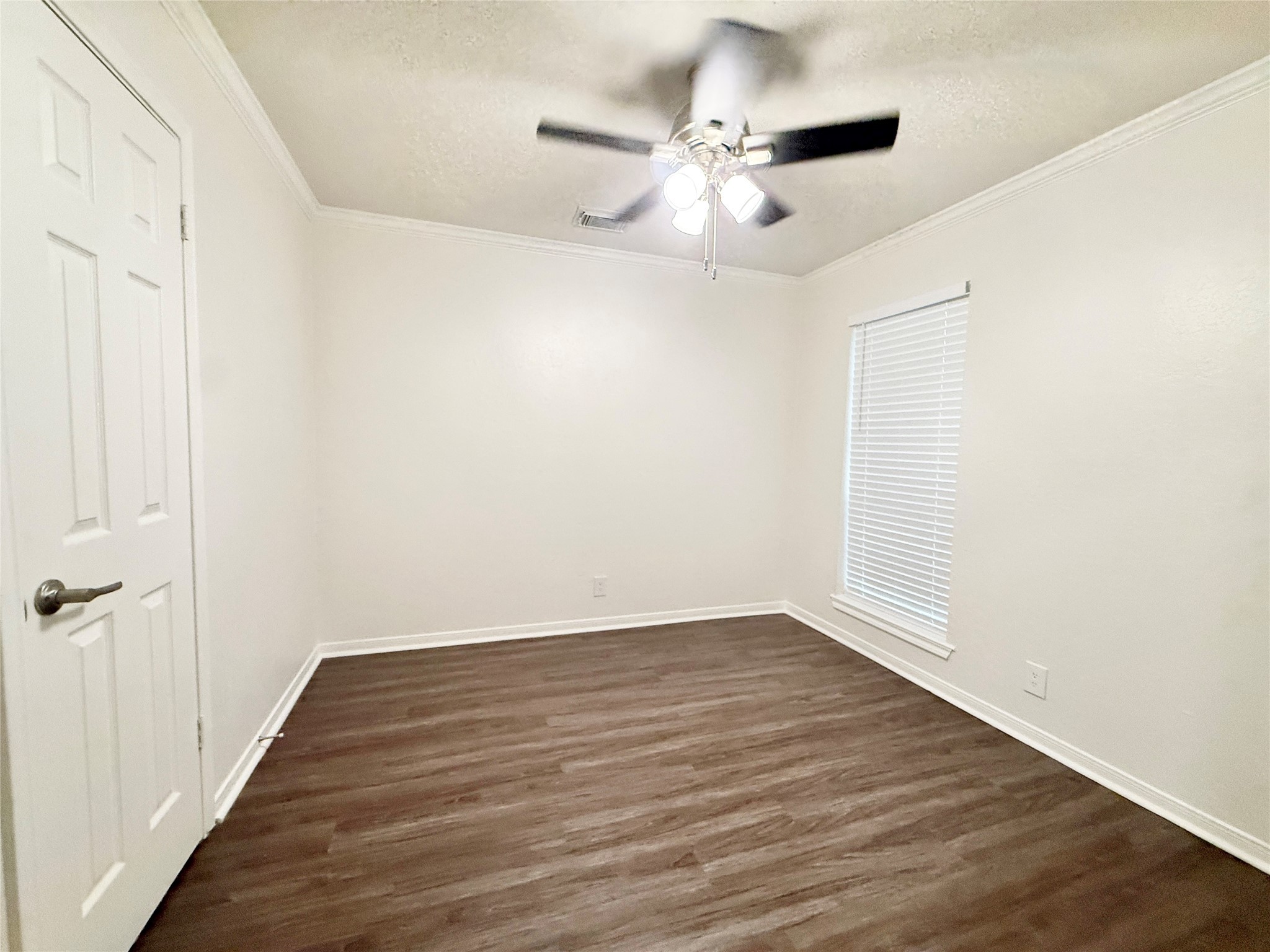 477 Oyster Creek Court Richwood, TX 77531 - Photo 31 of 33 an empty room with wooden floor fan and windows