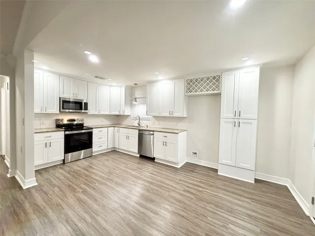 a kitchen with a white cabinets and white appliances