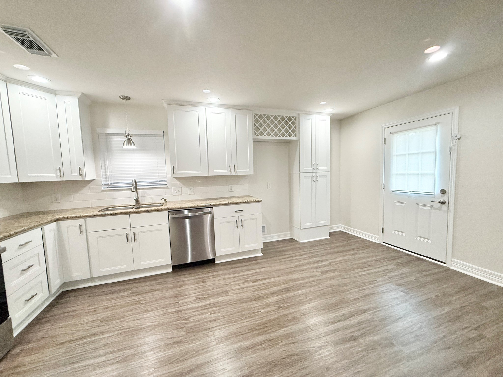 477 Oyster Creek Court Richwood, TX 77531 - Photo 9 of 33 a large white kitchen with a white wooden cabinets