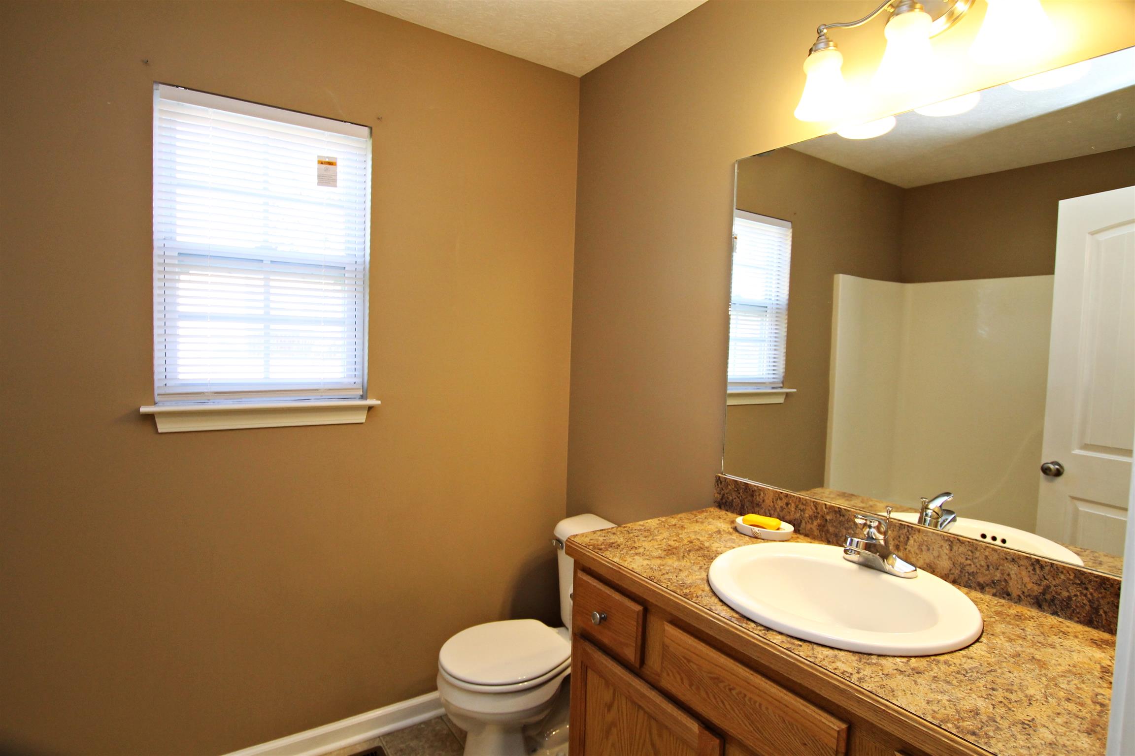 135 Filly Lane Springfield, TN 37172 - Photo 13 of 15 a bathroom with a toilet sink vanity and mirror