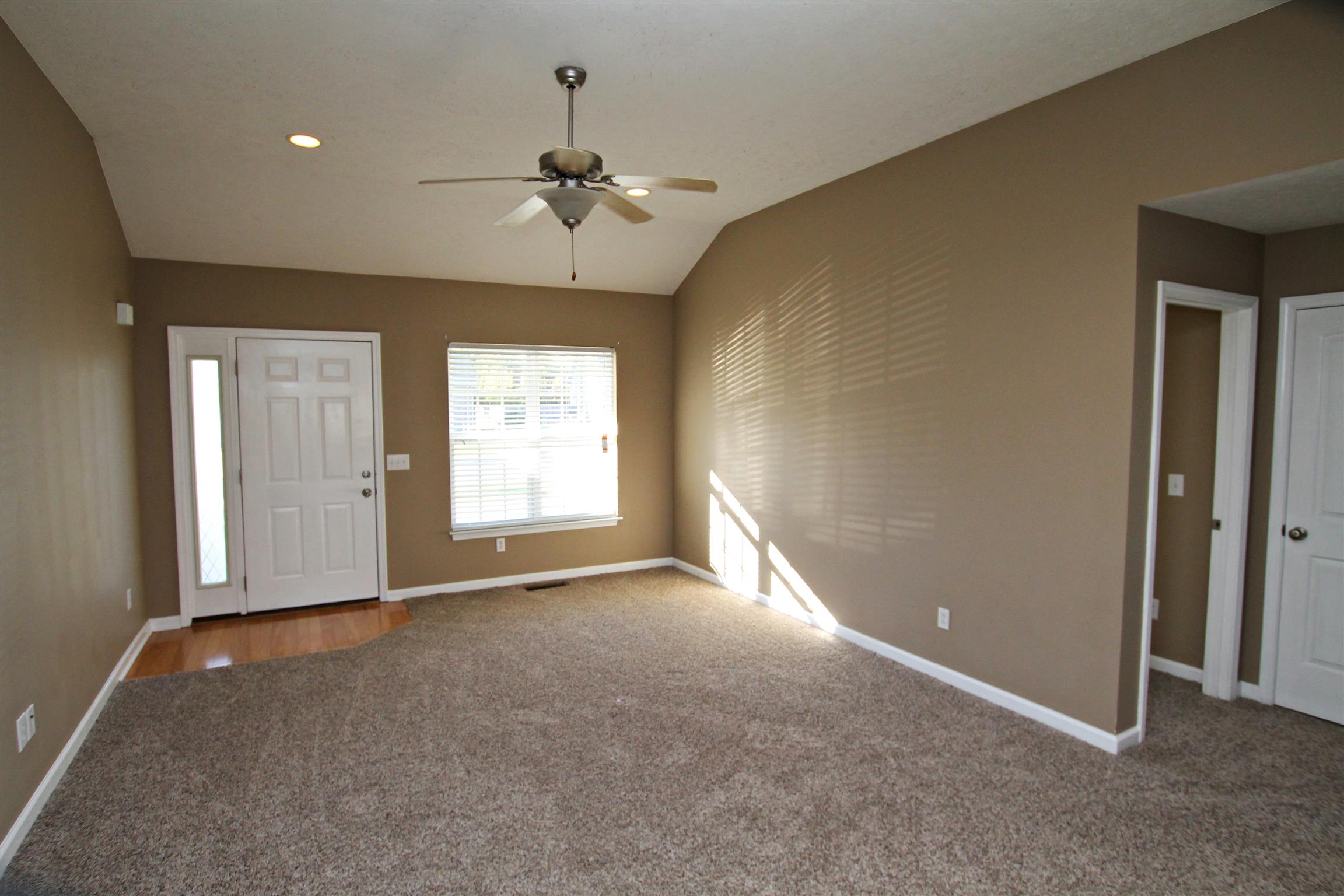 135 Filly Lane Springfield, TN 37172 - Photo 3 of 15 an empty room with windows and chandelier fan