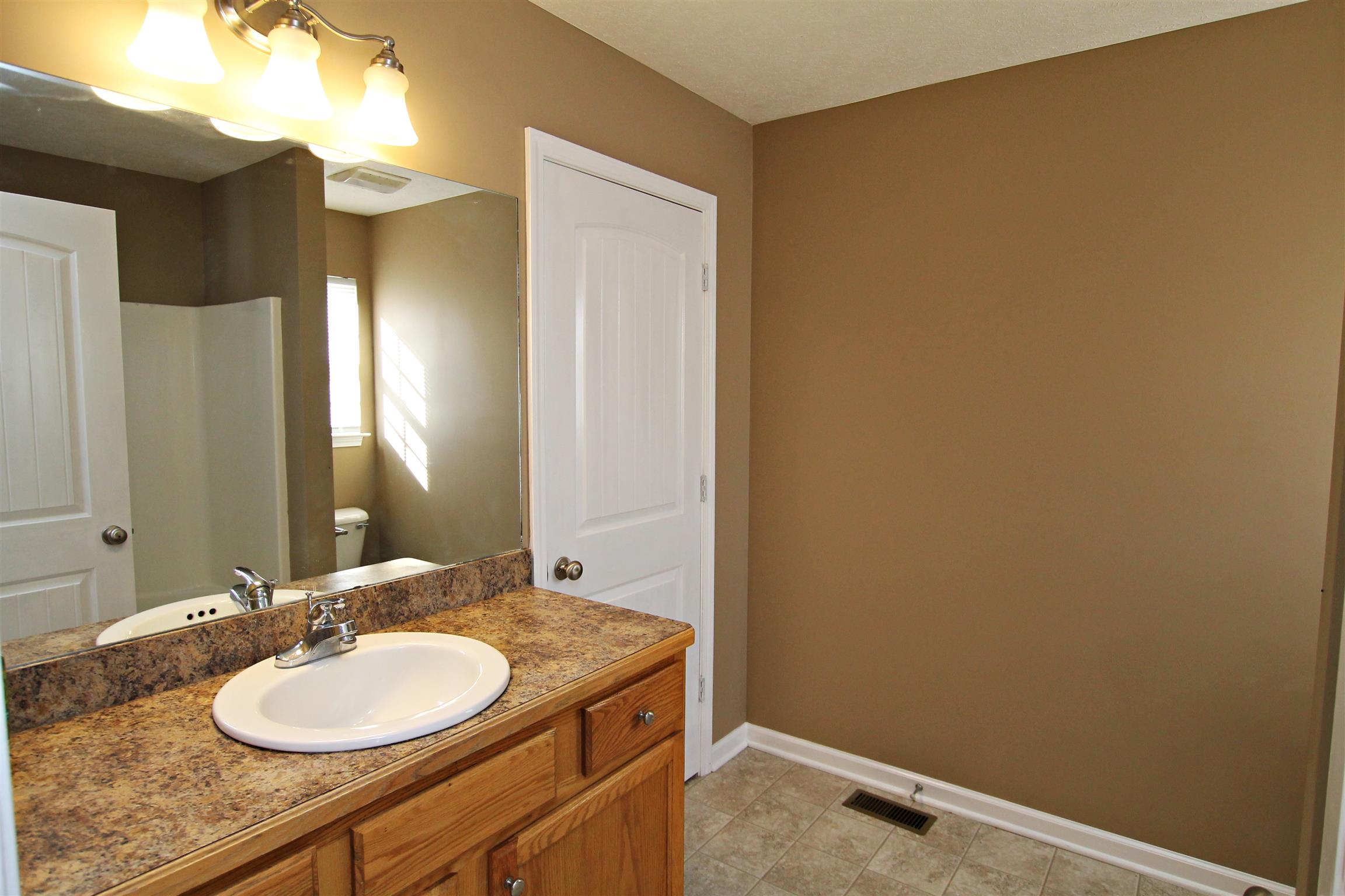 135 Filly Lane Springfield, TN 37172 - Photo 10 of 15 a bathroom with a granite countertop sink and a mirror