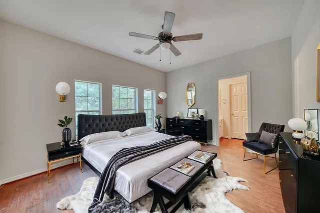 a bedroom with a bed and wooden floor