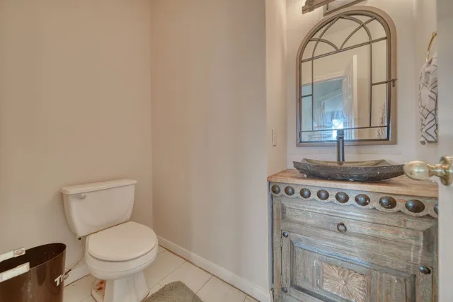a bathroom with a stove a sink and mirror