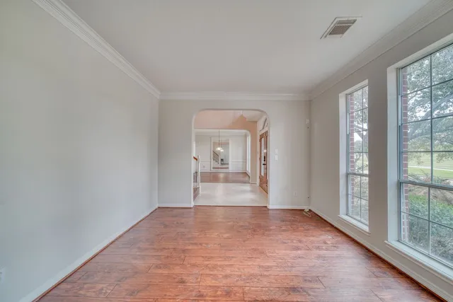a view of a room with window and wooden floor