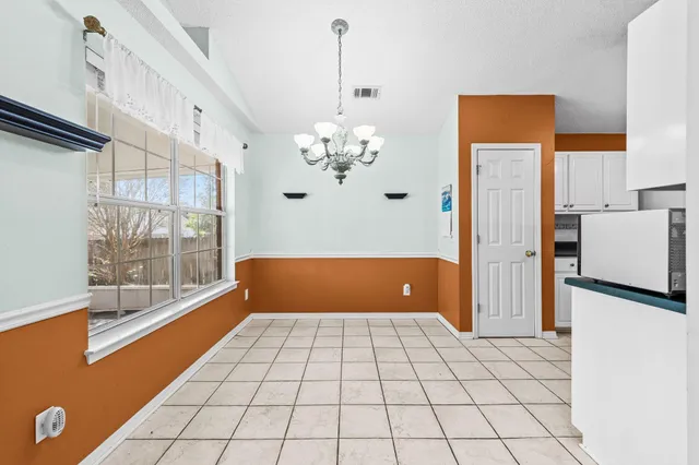 a view of a room with window and furniture